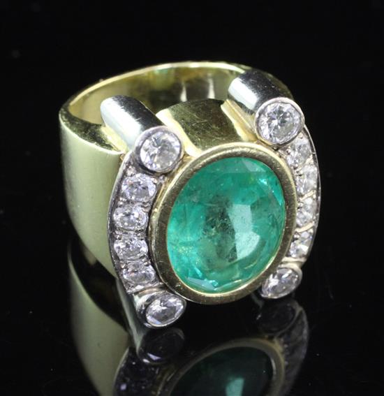 A stylish gold and platinum, emerald and diamond dress ring, size N.